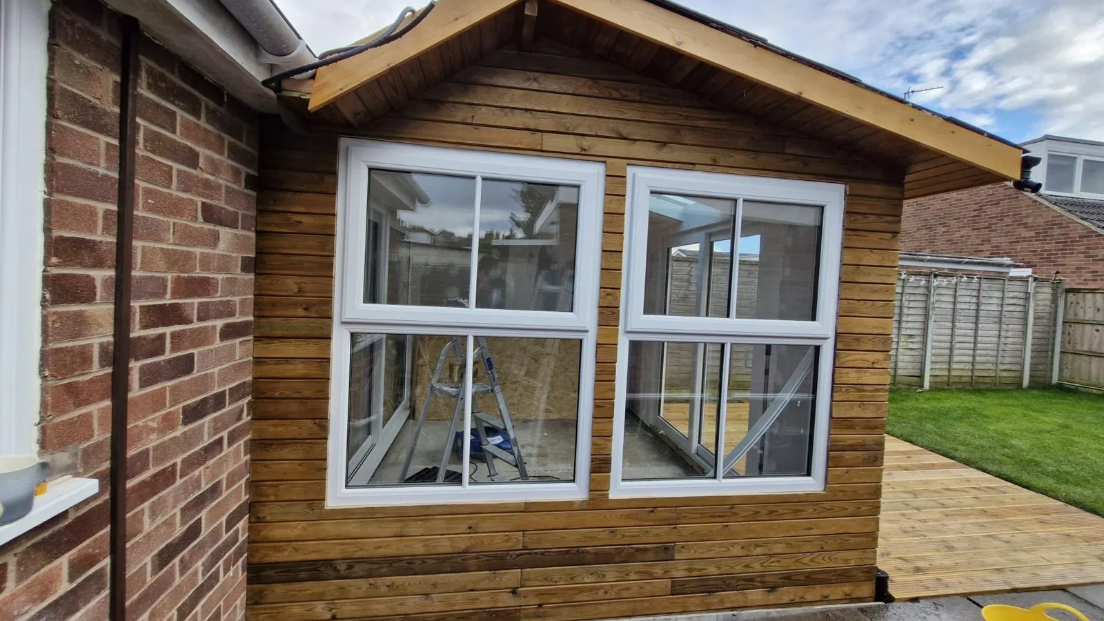 Bespoke timber-clad garden office in a Warwickshire garden, dual-aspect glazing, dedicated workspace inside